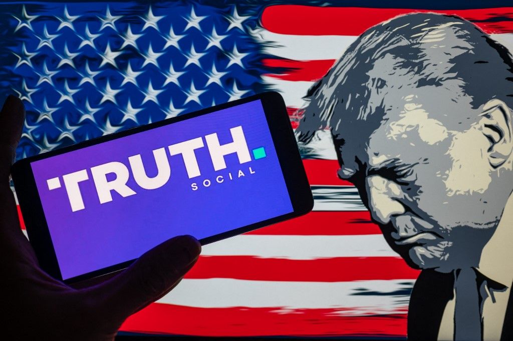 Donald J. Trump - Truth Photo IllustrationTruth Social logo displayed on a smart phone with Donald J. Trump seen in the background, in this photo illustration. On 03 September 2023 in Brussels, Belgium. (Photo illustration by Jonathan Raa/NurPhoto) (Photo by Jonathan Raa / NurPhoto / NurPhoto via AFP)