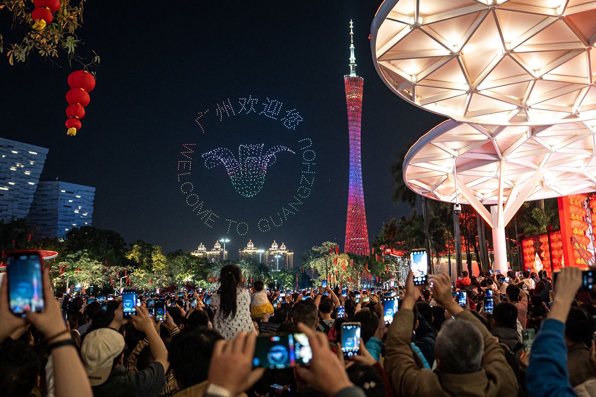 GUANGZHOU, CHINA - FEBRUARY 15: People gather to watch the Spring Festival Drone Performance held as part of the Lunar New Year celebrations on February 15, 2024 in Guangzhou, China. John Ricky / Anadolu (Photo by John Ricky / ANADOLU / Anadolu via AFP)