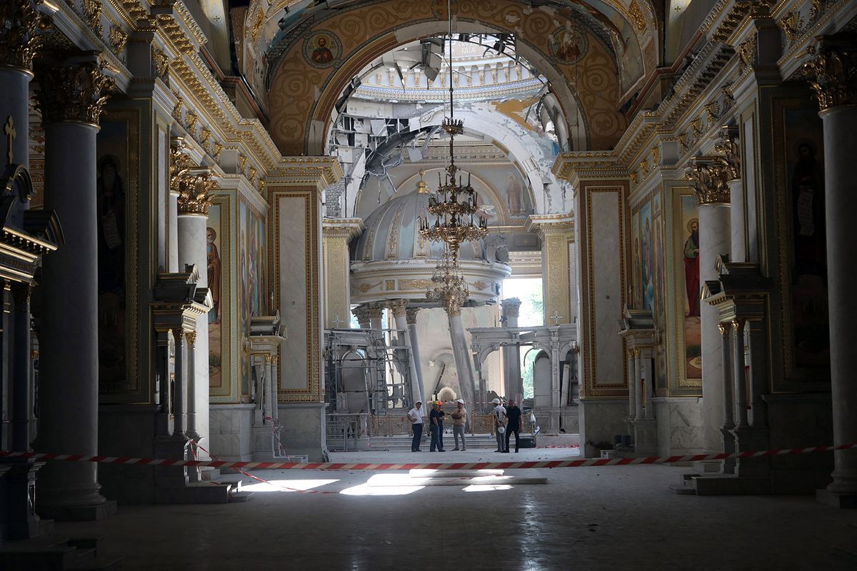 A comission examines destruction in Transfiguration Cathedral damaged as a result of a missile strike in Odesa on July 23, prior service on July 24, 2023, amid the Russian invasion of Ukraine. Ukraine on Sunday said 19 people, including four children, were wounded in a Russian overnight missile attack on Odesa that also killed one person. (Photo by Oleksandr GIMANOV / AFP)