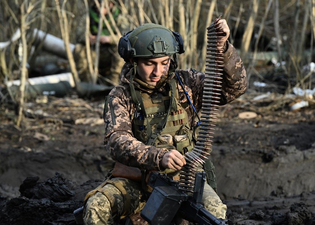 A Ukrainian serviceman flashes the sign of victory from an armoured combat vehicle on a road in the Donetsk region, amid the Russian invasion of Ukraine, on February 17, 2024. (Photo by Anatolii STEPANOV / AFP)