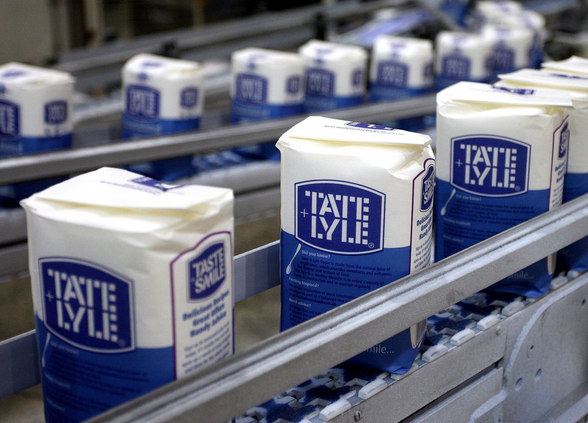 Packs of Tate & Lyle granulated sugar pass along the product