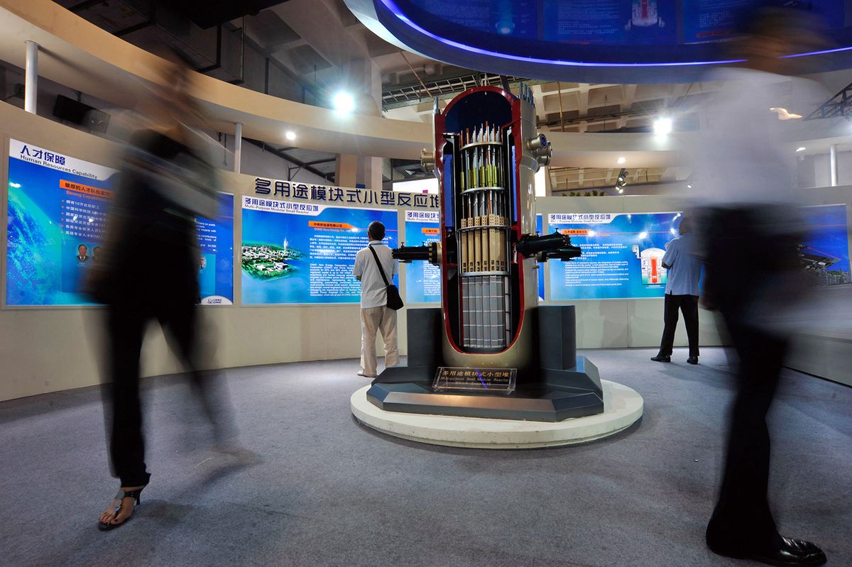 small modular reactor
China's CGN, CNNC establish Hualong nuclear power joint venture
--FILE--Visitors walk past a model of a multi-purpose small modular reactor on display at the stand of CNNC (China National Nuclear Corporation) during the 15th China Beijing International High-Tech Expo in Beijing, China, 25 May 2012.China's two biggest state-owned nuclear power operators announced a joint venture to export the country's third-generation nuclear power reactors internationally. A ceremony took place Thursday (17 March 2016) morning in Beijing at Hualong International Nuclear Power Technology Co.'s new headquarters, China General Nuclear Power Corp. said in an e-mailed statement. The company is an equal joint venture between CGN and China National Nuclear Corp. to develop and export the home-grown Hualong One reactor overseas, it said. CGN and CNNC signed a framework agreement in December to merge their Hualong One reactor designs and jointly market the technology internationally. China plans to build around 30 nuclear power units in countries along its "Belt and Road" initiative by 2030, CNNC chairman Sun Qin said in March. China has approved construction of six Hualong One reactors within the country, according to CGN. (Photo by Stringer / Imaginechina / Imaginechina via AFP)