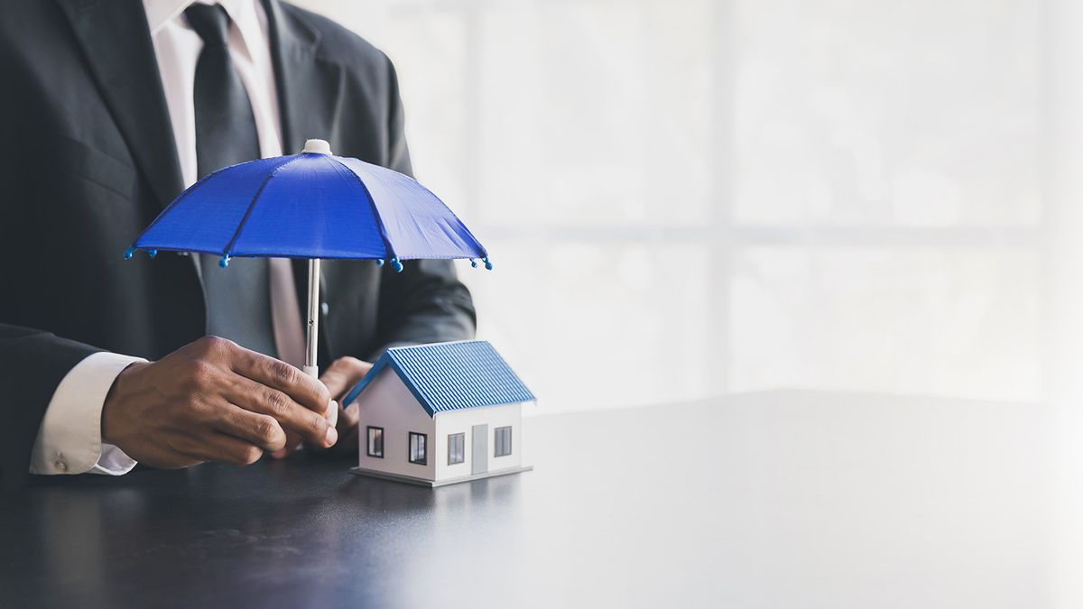 Man,Holding,Blue,Umbrella,And,White,House.,An,Insurance,Agent