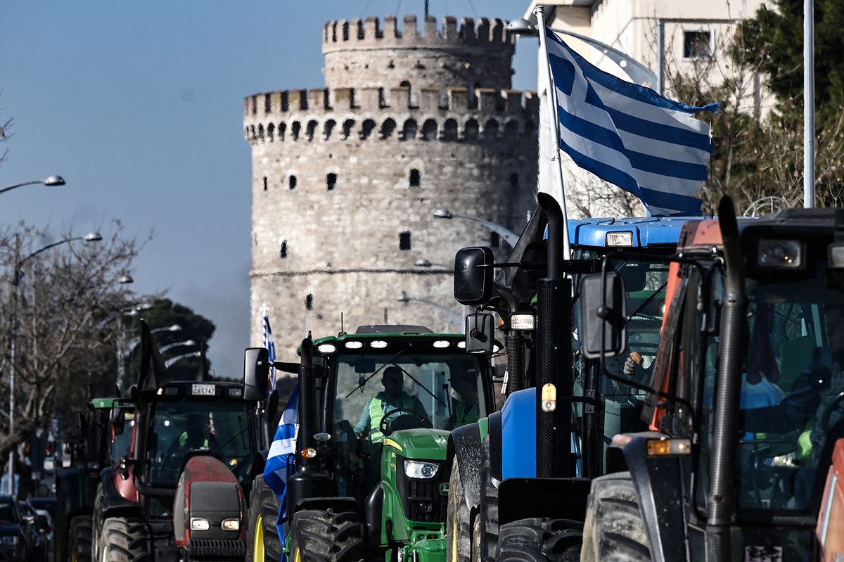 Farmers with their tractors drive to the Agrotica agricultural fair, in Thessaloniki on February 1, 2024, as they protest against rising operation and production costs, while also demanding better compensation for crop losses due to natural disasters and disease, as well as the construction of infrastructure to protect agriculture from extreme weather conditions. (Photo by Sakis MITROLIDIS / AFP)