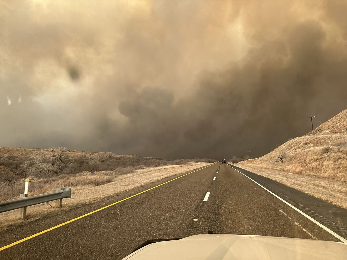 TEXAS, UNITED STATES - FEBRUARY 28: (----EDITORIAL USE ONLY - MANDATORY CREDIT - 'TEXAS A&M FOREST SERVICE / HANDOUT' - NO MARKETING NO ADVERTISING CAMPAIGNS - DISTRIBUTED AS A SERVICE TO CLIENTS----) Smoke rises on the roadway in Hutchinson County after the Juliet Pass fire broke out in Armstrong County, Texas, United States on February 28, 2024. Texas A&M Forest Service / Anadolu (Photo by Texas A&M Forest Service / ANADOLU / Anadolu via AFP)