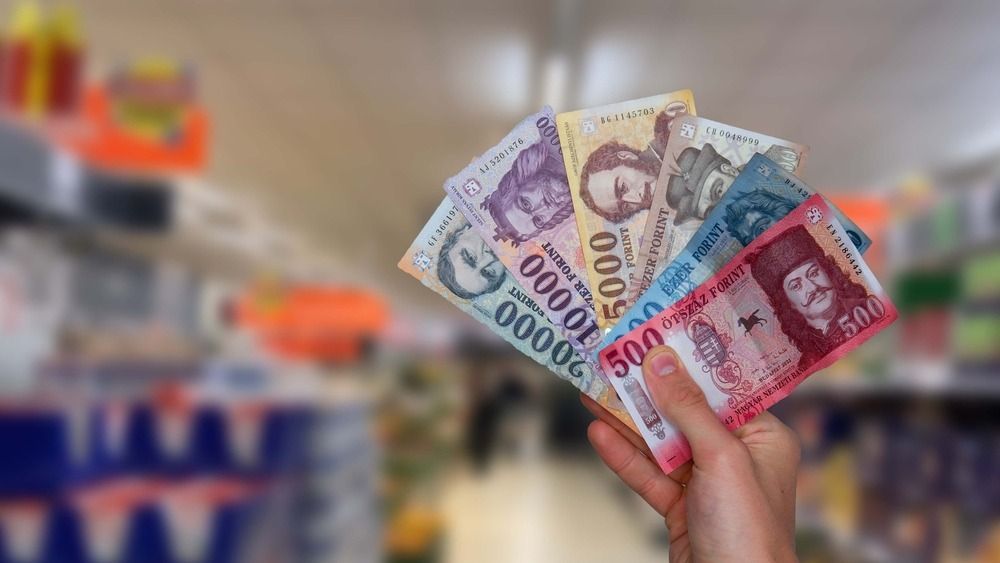 Hungarian,Forints,In,Hand,And,Grocery,Store,In,The,Background.
