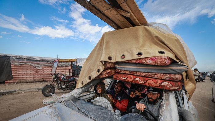 Palestinians fleeing Khan Yunis arrive in Rafah with their belongings in a damaged car on February 15, 2024, as battles raged in the sourthern Gaza Strip between Israel and the Palestinian militant group Hamas.
