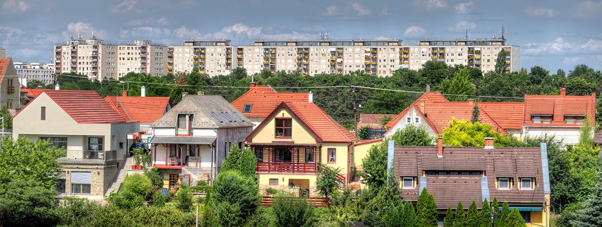 A,Residential,Area,With,Single-family,Houses,In,A,Suburb,OfA residential area with single-family houses in a suburb of Veszprem, a city near Lake Balaton in Hungary, with a block of flats on a hill on the horizon