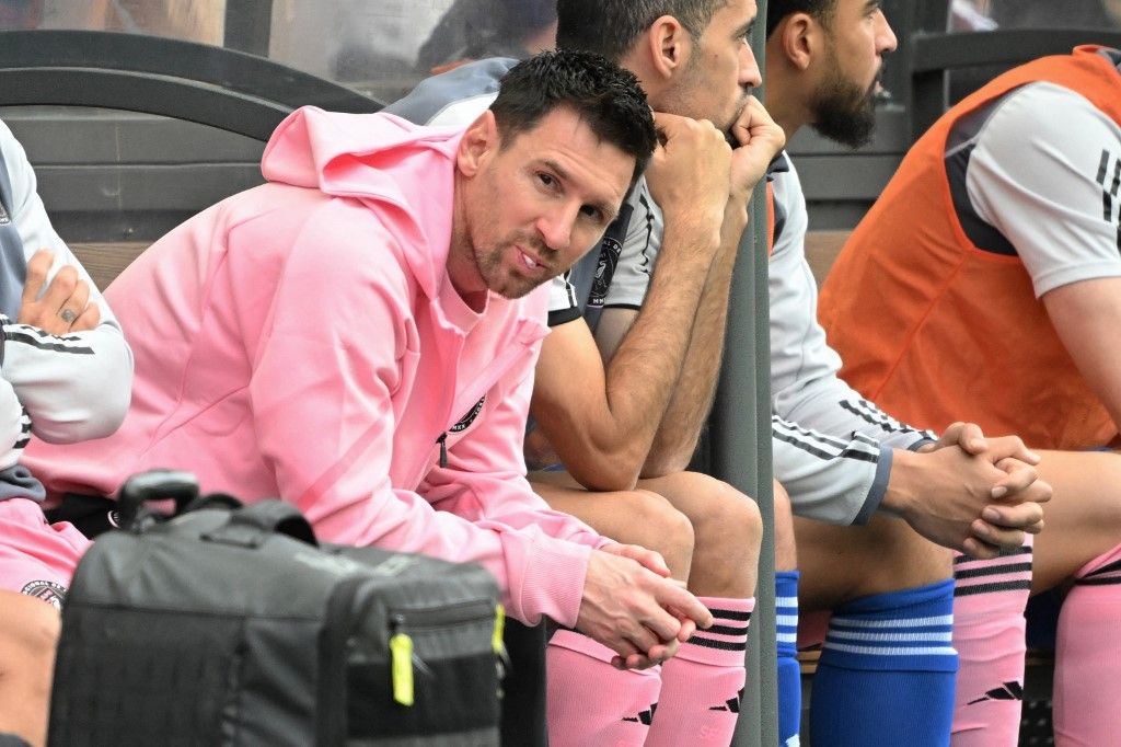 Inter Miami's Argentine forward Lionel Messi (L) sits on the bench during the friendly football match between Hong Kong XI and US Inter Miami CF in Hong Kong on February 4, 2024. Inter Miami were booed off the pitch after their injured superstar Lionel Messi failed to take the field in a pre-season friendly in Hong Kong. (Photo by Peter PARKS / AFP)