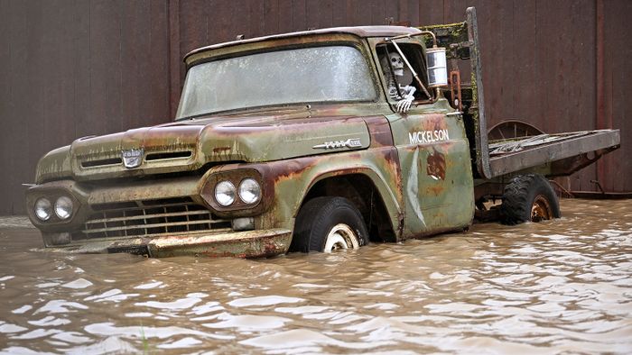 A truck sits in flood waters at the Mickelson Pumpkin Patch in Petaluma, California, on Sunday, February 04, 2024. The US West Coast was getting drenched on February 1 as the first of two powerful storms moved in, part of a "Pineapple Express" weather pattern that was washing out roads and sparking flood warnings. The National Weather Service said "the largest storm of the season" would likely begin on February 4. (Photo by JOSH EDELSON / AFP)