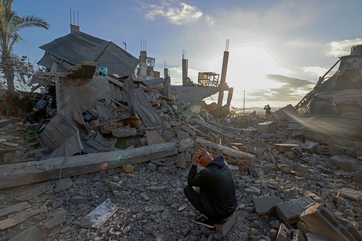A man sits amid the debris of destroyed houses in the aftermath of Israeli bombardment in Rafah in the southern Gaza Strip on February 22, 2024, amid continuing battles between Israel and the Palestinian militant group Hamas. (Photo by MOHAMMED ABED / AFP)