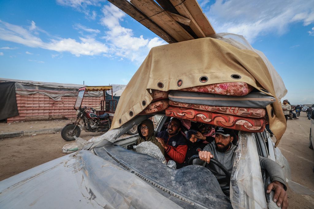 Palestinians fleeing Khan Yunis arrive in Rafah with their belongings in a damaged car on February 15, 2024, as battles raged in the sourthern Gaza Strip between Israel and the Palestinian militant group Hamas.
