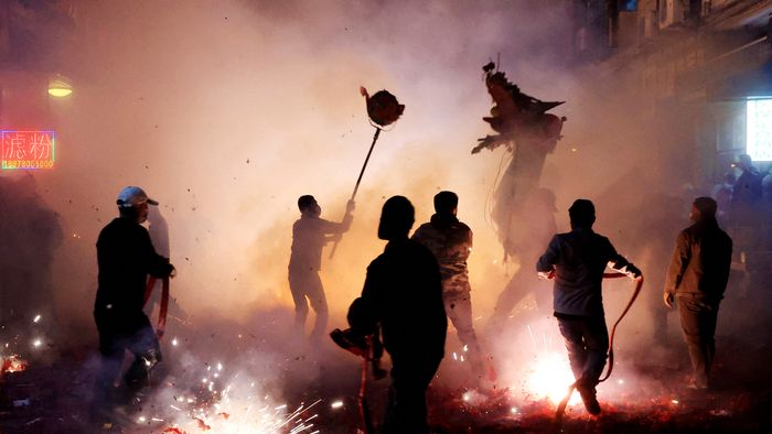 People perform a dragon dance amid fireworks in Rongan, in China’s southwest Guizhou province on the third day of the Lunar New Year of the Dragon on February 12, 2024. (Photo by AFP) / China OUT