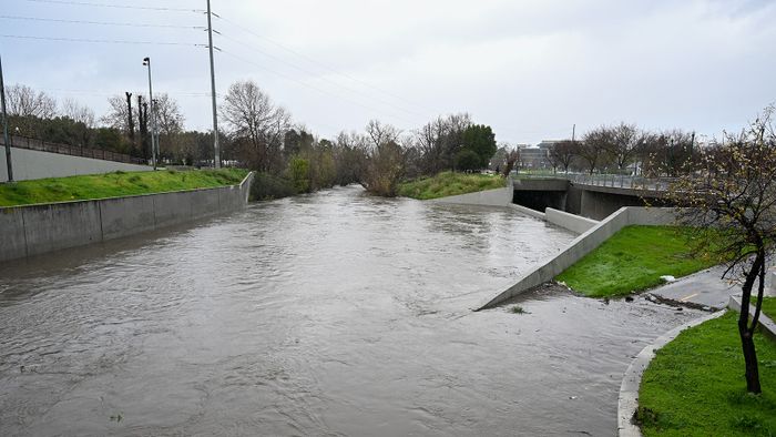 CALIFORNIA, USA - FEBRUARY 04: The Guadalupe River is starting to flood across sidewalk and bike path in downtown San Jose, as atmospheric river storms hit California, United States on February 4, 2024. Tayfun Coskun / Anadolu (Photo by Tayfun Coskun / ANADOLU / Anadolu via AFP)