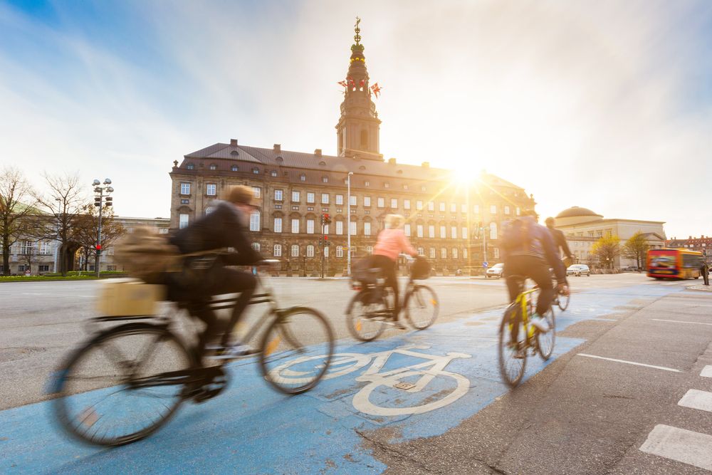 Blurred,People,Going,By,Bike,In,Copenhagen,,With,Christiansborg,Palace