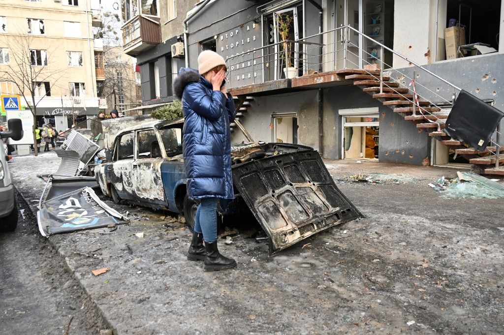 A woman reacts outside a damaged building in Kharkiv on January 24, 2024 one day after after a Russian missile barrage across the country. (Photo by SERGEY BOBOK / AFP)