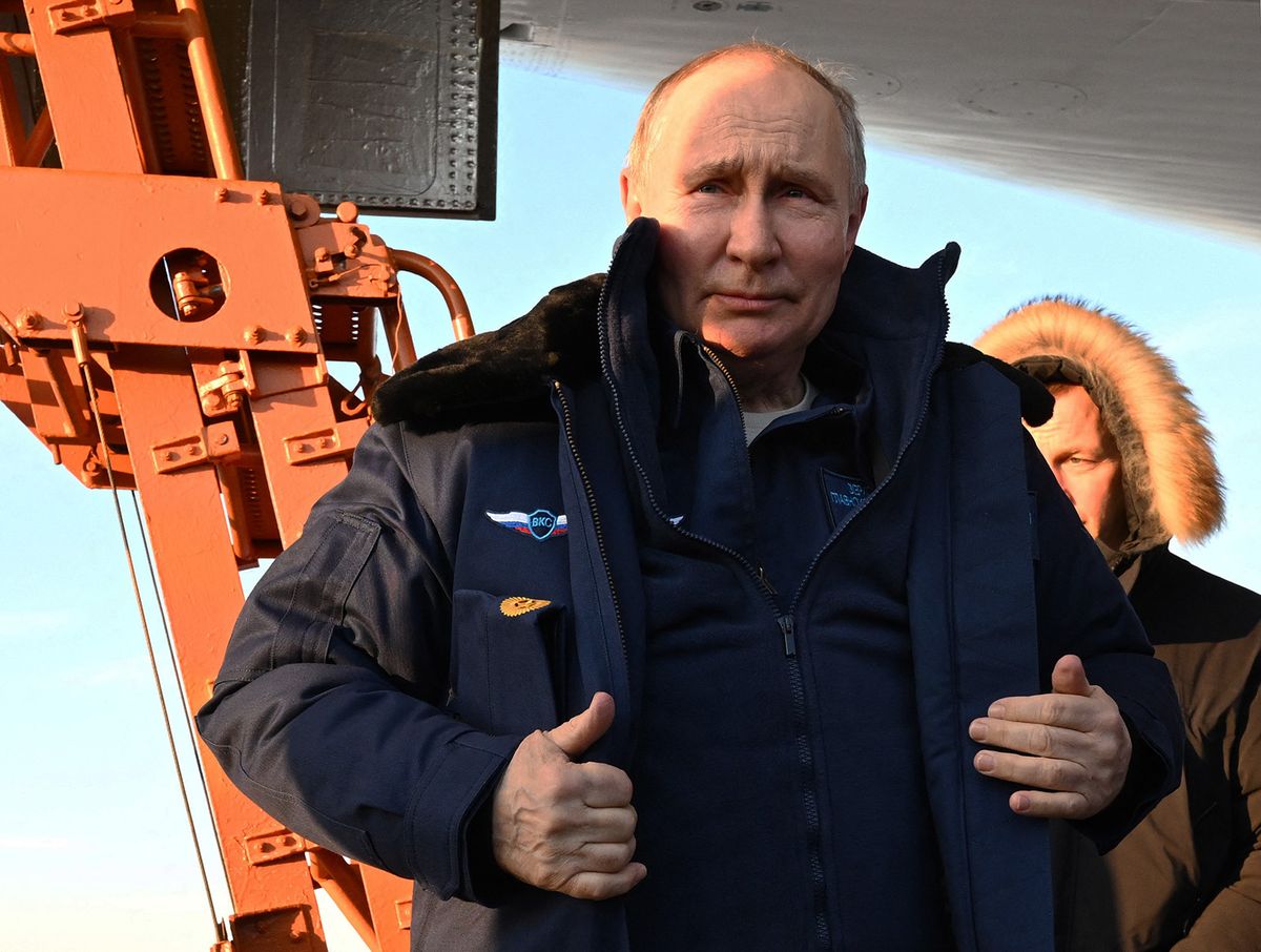 In this pool photograph distributed by Russian state agency Sputnik, Russia's President Vladimir Putin meets journalists after flying on a Tupolev Tu-160M strategic bomber in Kazan on February 22, 2024. (Photo by Dmitry AZAROV / POOL / AFP)