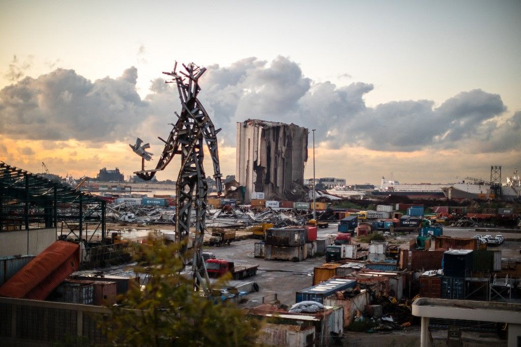 Beirut01/11/2024 Beirut, Lebanon. The destroyed grain silos and a sculpture made from salvaged steel following the explosion stand in the port of Beirut as the sun sets on Lebanon. (Photo by Oliver Marsden / Middle East Images / Middle East Images via AFP)