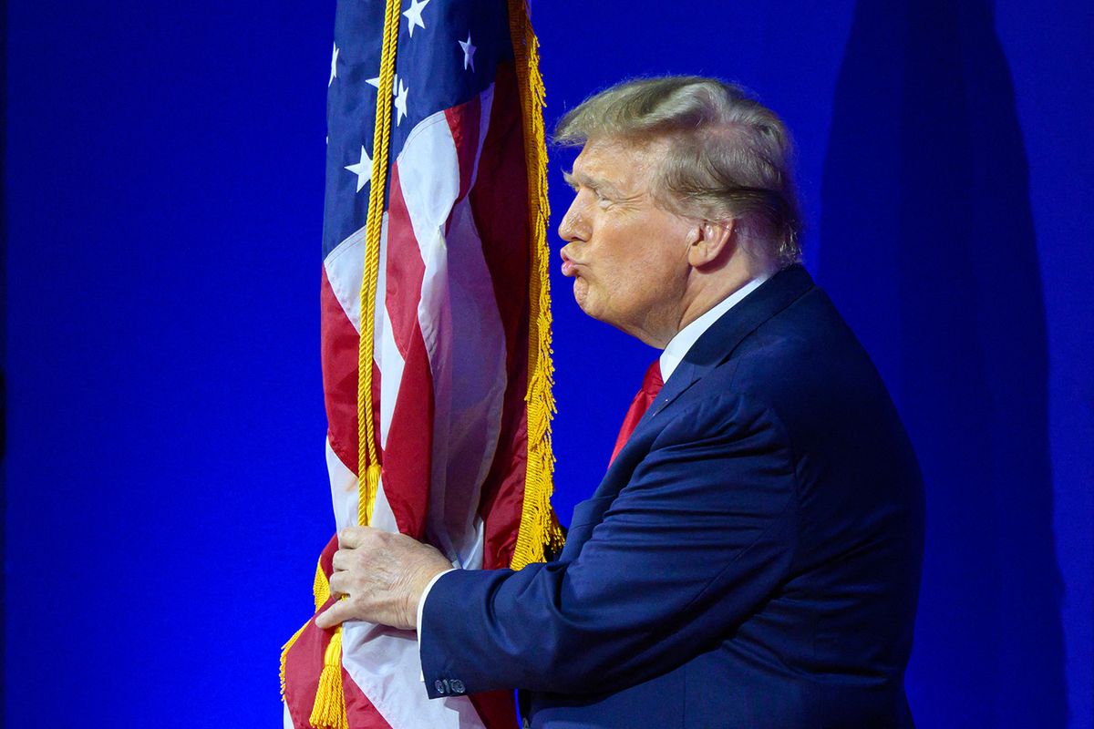 (FILES) Former US president and 2024 presidential hopeful Donald Trump kisses the US flag as he arrives to speak during the annual Conservative Political Action Conference (CPAC) meeting on February 24, 2024, in National Harbor, Maryland. On March 4, 2024, the US Supreme Court unanimously rejected Colorado's bid to take Trump off primary ballot. (Photo by Mandel NGAN / AFP)