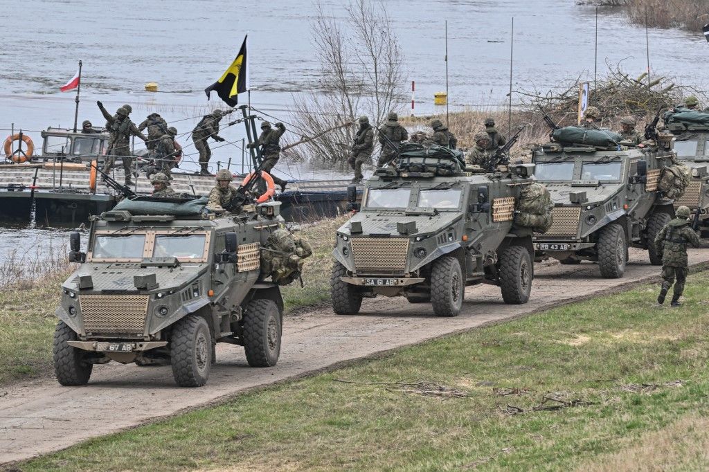 DRAGON-24 NATO military defense drills in PolandKORZENIEWO, POLAND - MARCH 04: British soldiers drive armored vehicles after crossing the Vistula River on a mobile platform during the DRAGON-24 NATO military defense drills on March 04, 2024 in Korzeniewo, Poland. In the first half of 2024, NATO is conducting a series of exercises under the Steadfast Defender 24 (STDE-24) drill. The exercises, which will take place mainly in Central Europe, will involve some 90,000 troops from all NATO countries as well as Sweden. Omar Marques / Anadolu (Photo by Omar Marques / ANADOLU / Anadolu via AFP)