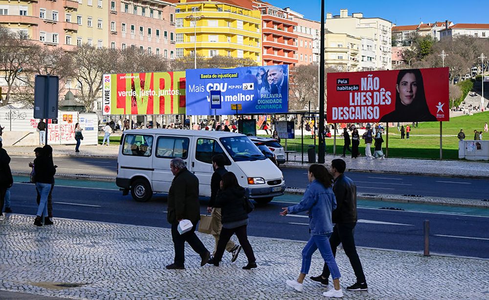Portuguese Political Parties Advertise For Early Legislative Elections
LISBON, PORTUGAL - JANUARY 20: Pedestrians walk across the street in front of Livre, CDU (PCP-PEV) and Bloco de Esquerda political parties billboard campaign posters in Alameda Dom Afonso Henriques for the Portuguese early legislative elections to be held on March 10, 2024, on January 20, 2024, in Lisbon, Portugal. The leaders of the governmental Socialist Party, Pedro Nuno Santos, and the main opposition Social Democratic Party, Luis Montenegro, will lead their parties for the first time in this occasion. The Portuguese crisis began on November 7, 2023, when the Public Prosecutor's Office ordered a search that included the Prime Minister's office, the Ministry of the Environment and Climate Action and the Ministry of Infrastructure, while investigating active and passive corruption and prevarication in relation to concessions for lithium mining in northern Portugal, a project for a green hydrogen production plant and a project for a data center. This led to the resignation of Antonio Costa and the fall of Portugal's XXIII Constitutional Government. President Marcelo Rebelo de Sousa decreed the dissolution of parliament on January 15, previously announced on November 09, 2023, and the calling of early legislative elections. (Photo by Horacio Villalobos#Corbis/Corbis via Getty Images)