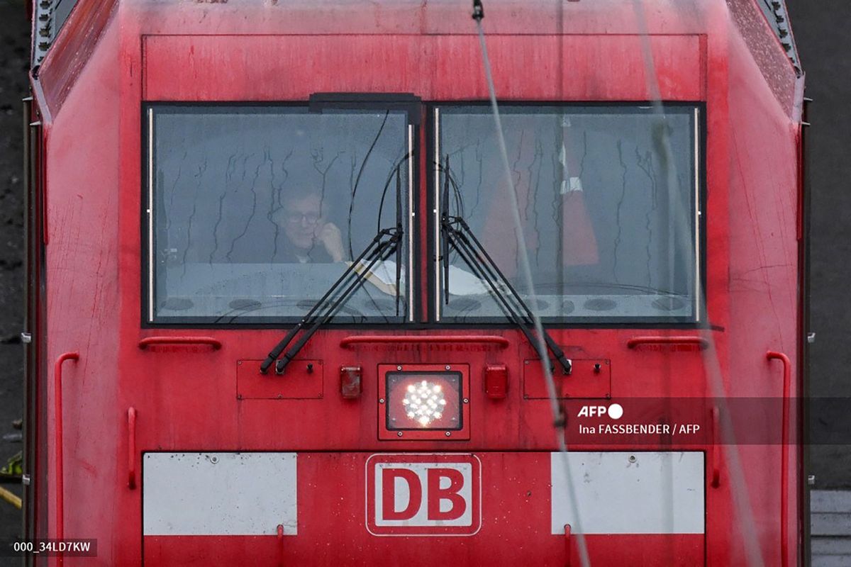 A train conductor sits in the driver's cab of a railway locomotive of German railway operator Deutsche Bahn DB at the freight station in Hagen, western Germany on March 11, 2024. Germans faced more travel upheaval after train drivers announced on March 10 a new 24-hour stoppage, hot on the heels of a strike announcement by Lufthansa cabin crew. The GDL train drivers' union said the latest strike affecting passenger services would start at 0100 GMT on March 12 and last until 0100 GMT March 13. For cargo services the strike would start a few hours earlier, the union said in a statement, blaming deadlocked talks with rail operator Deutsche Bahn. Deutsche Bahn on March 11 filed a lawsuit against the announced new strike by the train drivers' union GDL. (Photo by Ina FASSBENDER / AFP)