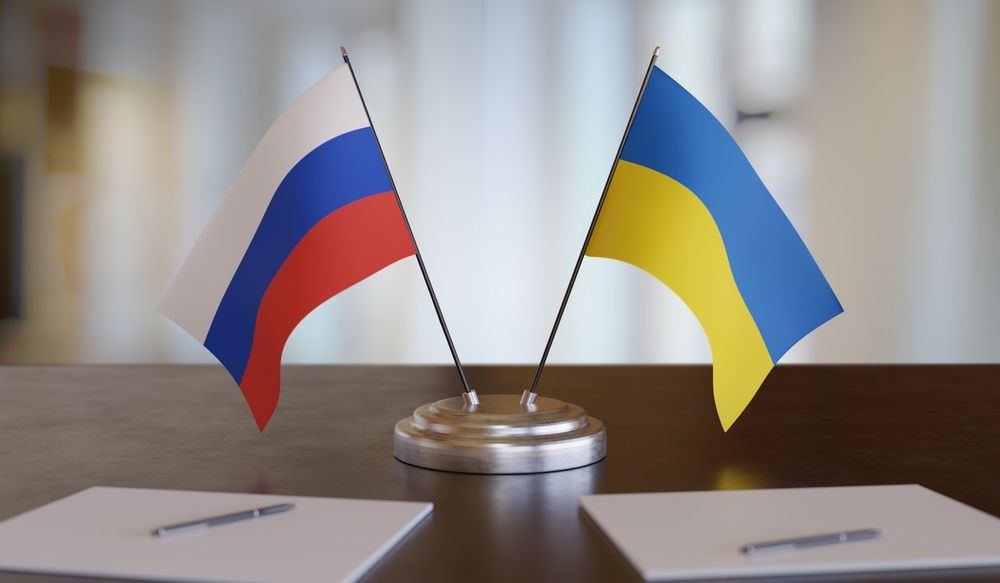 Ukrainian,And,Russian,Flags,On,Table.,Negotiation,Between,Russia,And