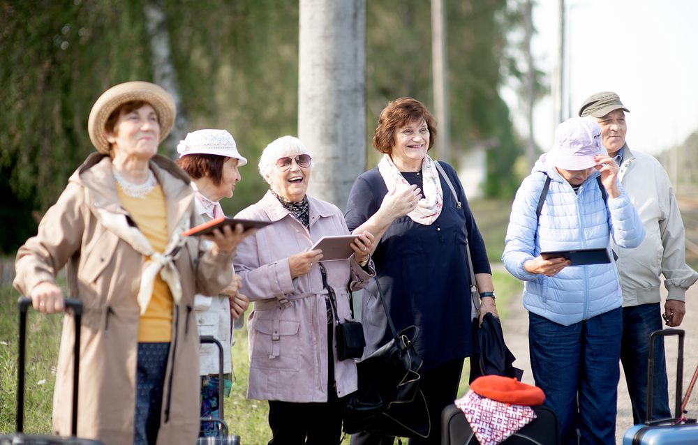 A,Group,Of,Positive,Senior,Elderly,People,Travelers,Using,Tablets