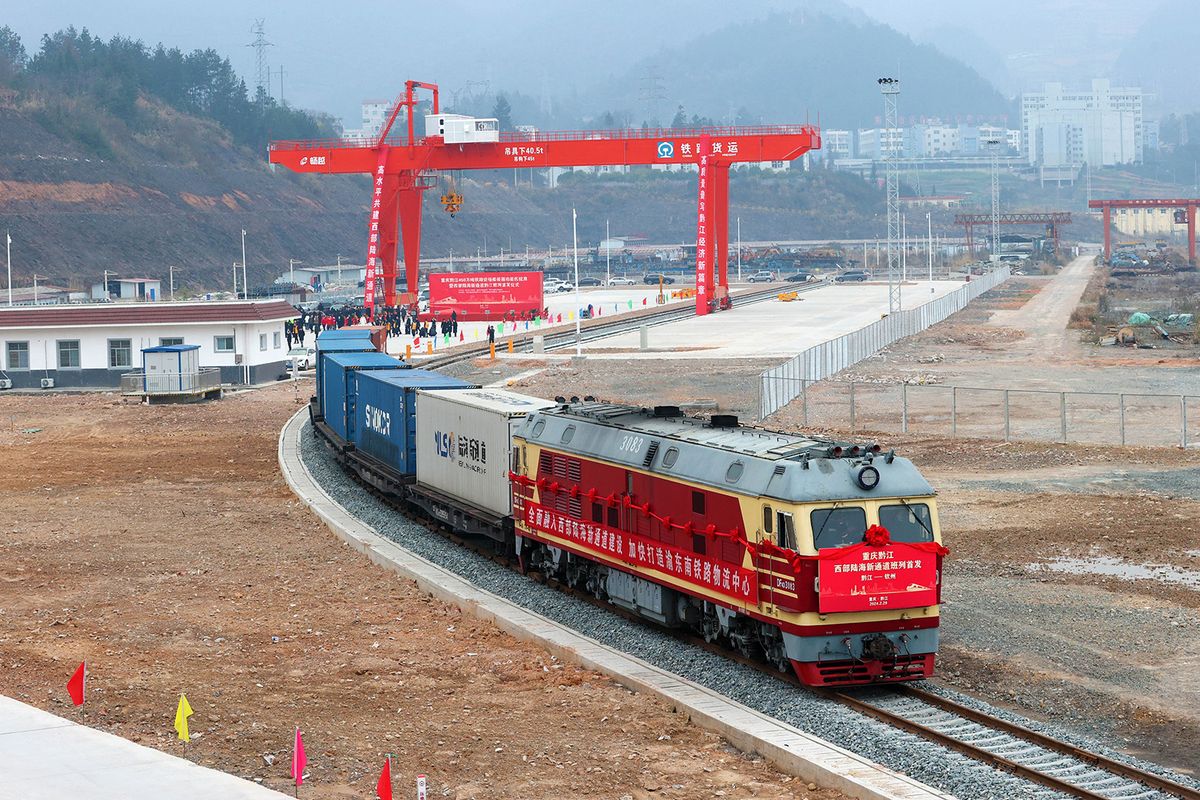 The first container train is carrying glass bottles, cans, tires, and other goods as it leaves the container functional area of the cargo yard of Qianjiang Station of the Chongqing-Huaihua Railway in Chongqing, China, on February 29, 2024. (Photo by Costfoto/NurPhoto) (Photo by CFOTO / NurPhoto / NurPhoto via AFP)