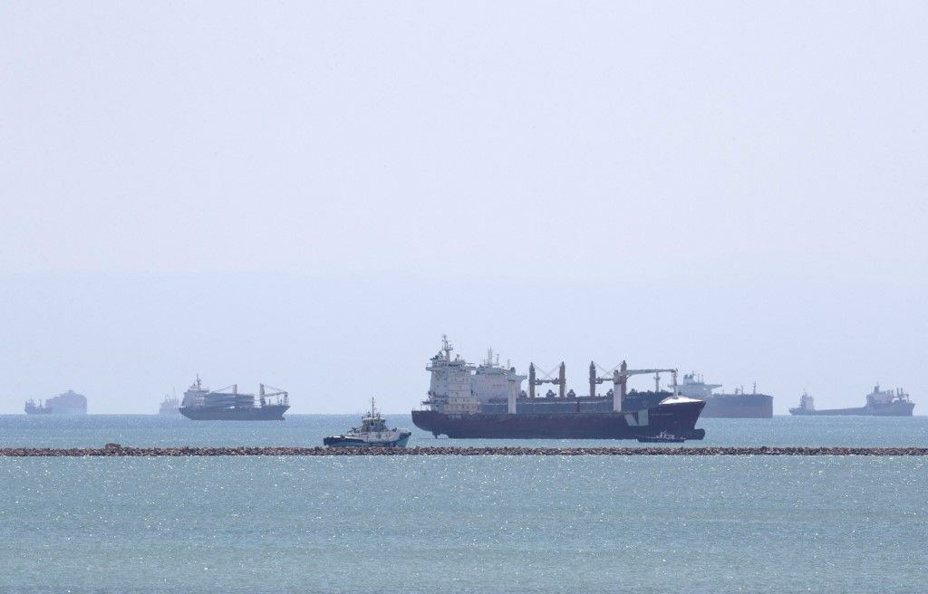 This picture taken on March 28, 2021 shows the Gibraltar-flagged container ship Indian Express (C-front) and the Panama-flagged container ship Elegant (C-behind) near the entrance of the Suez Canal, by Egypt's Red Sea port city of Suez. (Photo by Ahmed HASAN / AFP)