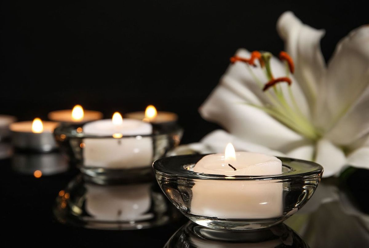 Burning,Candles,And,Lily,Flower,On,Dark,Background