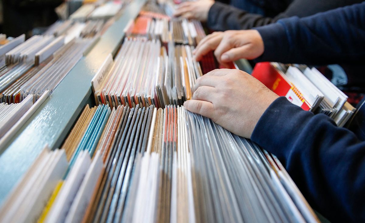 Customers shop for special edition vinyl records at Dusty Groove music store during the Record Store Day in Chicago on April 13, 2019. Record Store Day was founded in 2007 and is now celebrated at stores around the world, with hundreds of recording and other artists participating in the day by making special appearances, performances, meet and greets with their fans, the holding of fund raisers for community non-profits, and the issuing of special vinyl releases. (Photo by KAMIL KRZACZYNSKI / AFP)