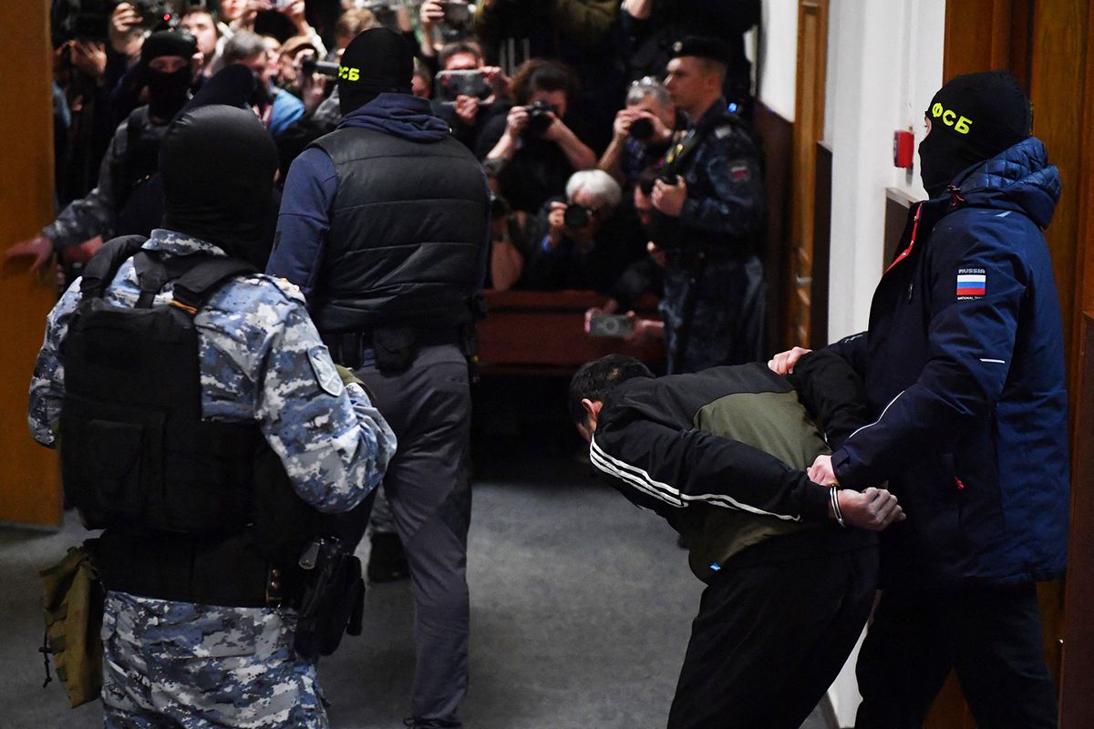 A man suspected of taking part in the attack of a concert hall that killed 137 people, the deadliest attack in Europe to have been claimed by the Islamic State jihadist group, is escorted by Russian law enforcement officers prior to his pre-trial detention hearing at the Basmanny District Court in Moscow on March 24, 2024. At least 137 people, including three children, were killed when camouflaged gunmen stormed the Crocus City Hall, in Moscow's northern suburb of Krasnogorsk, and then set fire to the building on March 22 evening. (Photo by Olga MALTSEVA / AFP)