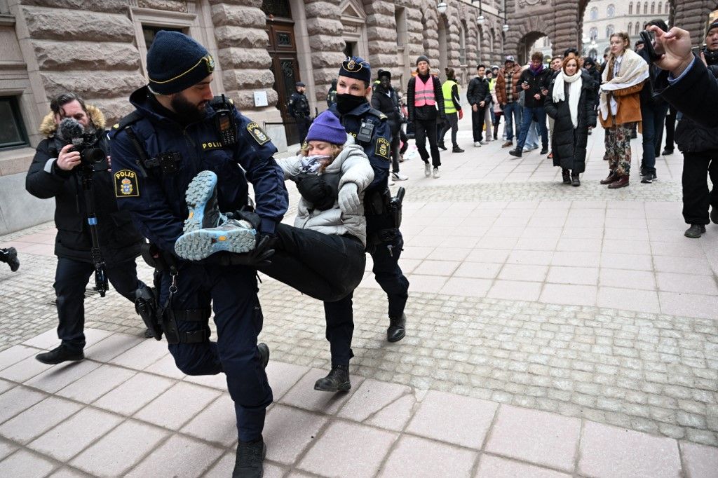 Swedish climate activist Greta Thunberg is carried away by police after staging a sit-in outside the Swedish parliament, the Riksdagen, to demonstrate for climate action, on March 13, 2024 in Stockholm, Sweden. (Photo by Fredrik SANDBERG / TT NEWS AGENCY / AFP) / Sweden OUT