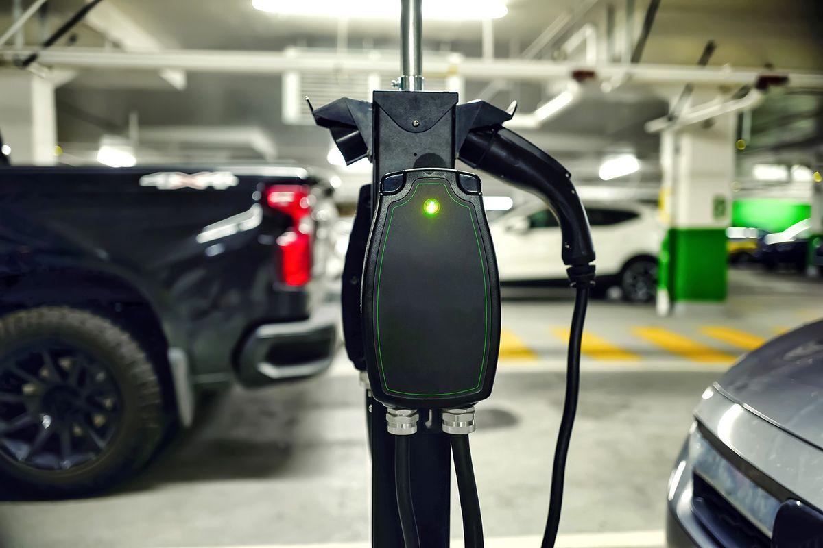 Modern,Ev,Charging,Station,With,Cable,And,Plug,Connected,At