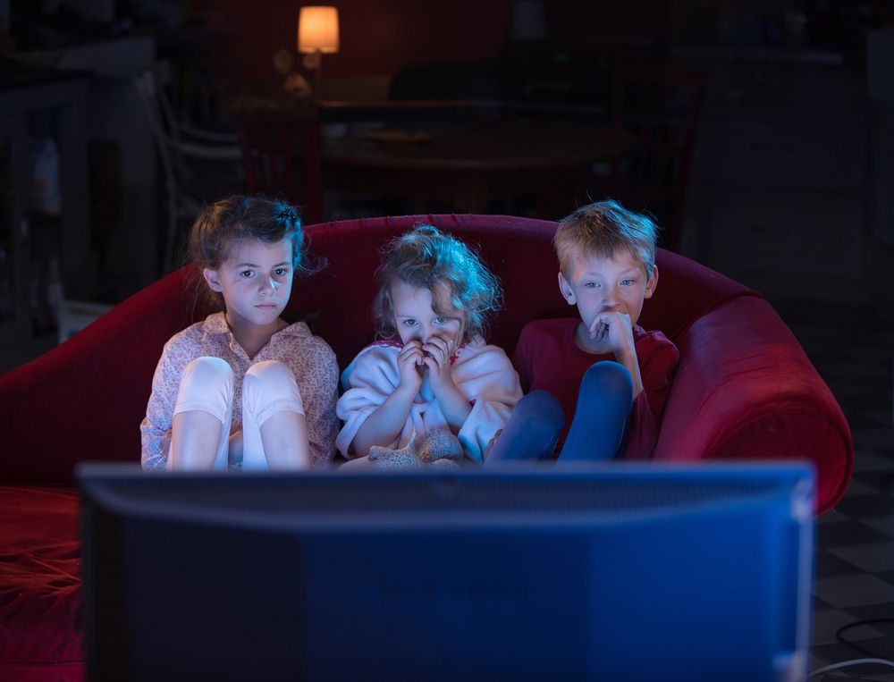 At,Home,By,Night,,Three,Scared,Kids,Watching,Tv