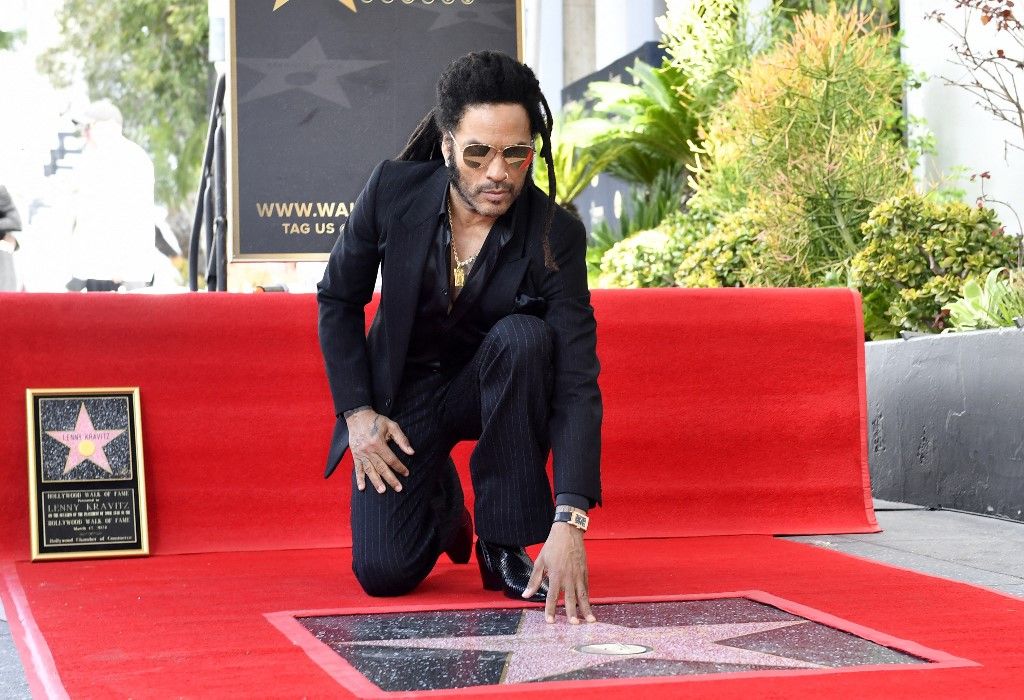 US musician Lenny Kravitz poses on his newly unveiled star during his Walk of Fame ceremony in Los Angeles, California, on March 12, 2024. (Photo by VALERIE MACON / AFP)