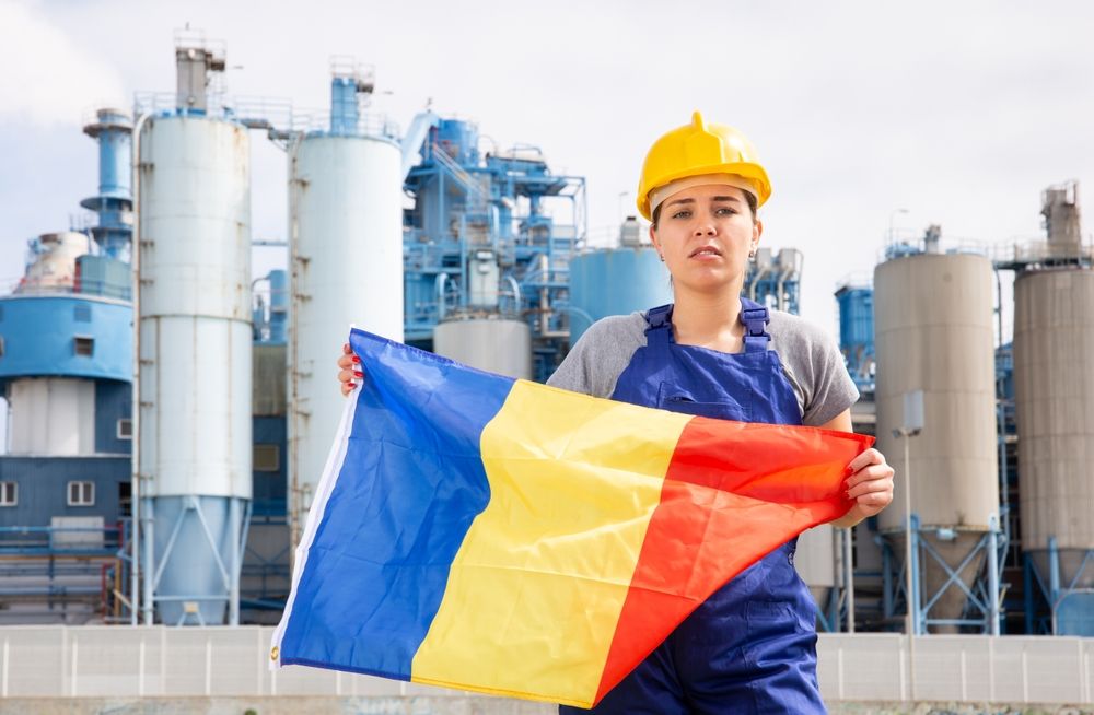 Sad,Female,Worker,In,Hardhat,With,Romanian,Flag,Standing,In