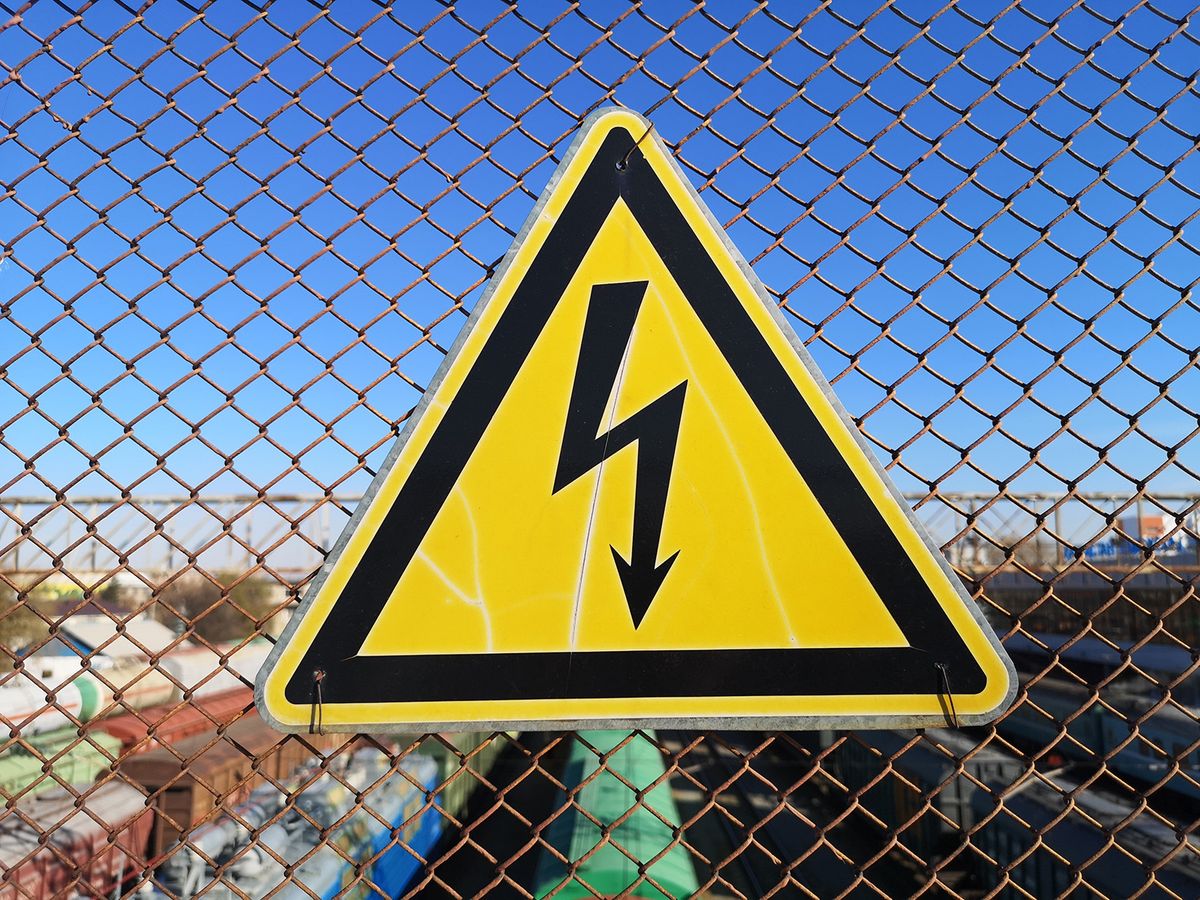 Sign,,Danger,Of,Electric,Shock,On,A,Railway,Bridge.,Yellow