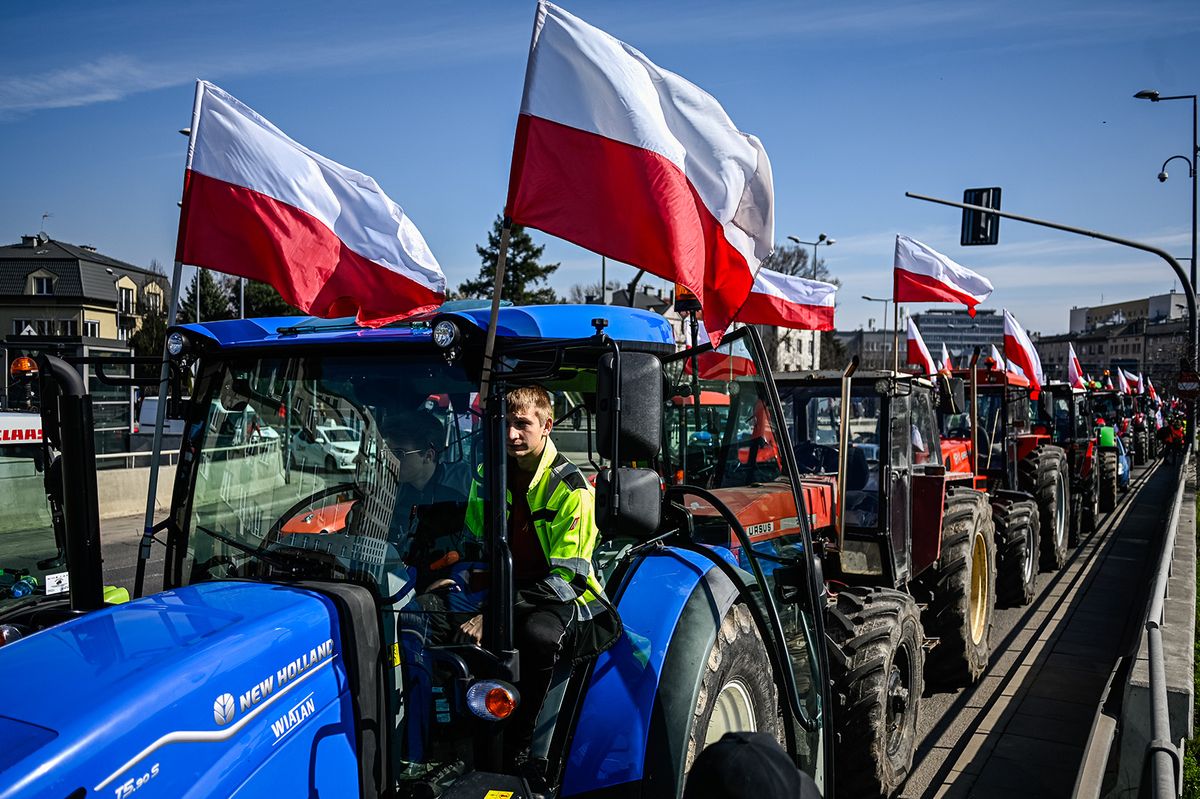 KRAKOW, POLAND - MARCH 20: A Polish farmer sits inside his tractor as he and others block the main roundabout of Krakow's ring road during a national farmers protest on March 20, 2024 in Krakow, Poland. For the last two months, Polish farmers have been protesting, notably with a blockade at the Polish-Ukrainian border and most recently at the Polish-German border, as they demand reform of the EU Green Deal and a halt to imports from the war-torn country of Ukraine. Today, more than 500 blockades are taking place around Poland, as farmers claim that the recent EU reforms on the Green Deal do not meet their demands. (Photo by Omar Marques/Getty Images)