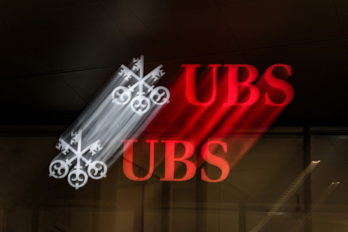 This slow shutter speed photograph taken on October 6, 2023, shows a logo sign of Swiss banking giant UBS on a building in Lugano, southern Switzerland. (Photo by Fabrice COFFRINI / AFP)