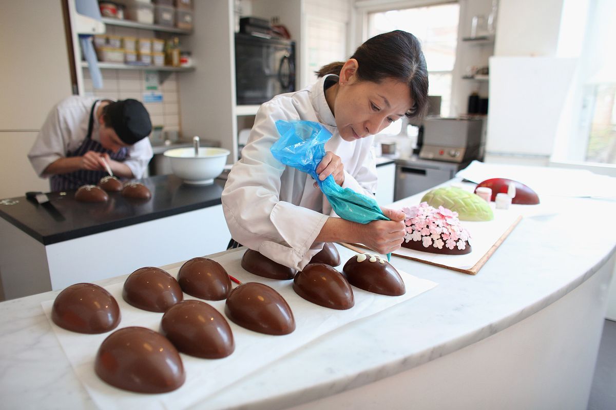 LONDON, ENGLAND - MARCH 28:  Head chocolatier Chika Watanabe creates handmade Easter eggs in the 'Melt' chocolate shop in Notting Hill on March 28, 2013 in London, England. Easter represents the busiest time of year for the luxury chocolate retailer 'Melt' who, in addition to their regular customised Easter eggs, also make a range of large themed eggs with a limited edition of 5.  (Photo by Oli Scarff/Getty Images)