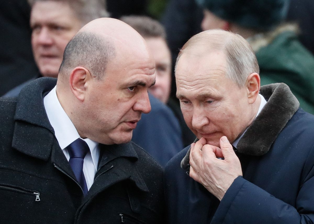 Russian President Vladimir Putin (R) speaks with Russian Prime Minister Mikhail Mishustin during the wreath-laying ceremony at the Tomb of the Unknown Soldier by the Kremlin wall to mark the Defender of the Fatherland Day in Moscow on February 23, 2020. The Defender of the Fatherland Day, celebrated in Russia on February 23, honours the nation's army and is a nationwide holiday. (Photo by YURI KOCHETKOV / POOL / AFP)