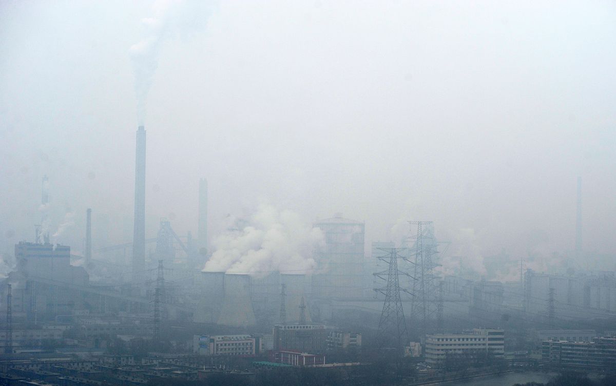 Smoke is discharged from chimneys at a factory in heavy smog in Taiyuan city, north China's Shanxi province, 6 January 2017.China's top environmental watchdog Friday (6 January 2017) named and shamed a list of companies not complying with anti-smog environmental measures, with dozens of cities in the country suffering from polluted air all this week. Yusheng building material company in Hebi city, central China's Henan Province, started its own power production generator without permission and without taking any environmental protection steps, after its electricity supply was cut off by the local government, the Ministry of Environmental Protection said. The ministry in late December dispatched 10 inspection teams to different provincial regions nationwide to supervise the implementation of environmental measures taken by key industrial enterprises. Seven companies, including Tengfei wood industry company in Hebei Province, did not abide by local government emergency measures such as halting or reducing production when localities suffer from air pollution, a ministry statement said. (Photo by Yin ming / Imaginechina / Imaginechina via AFP)