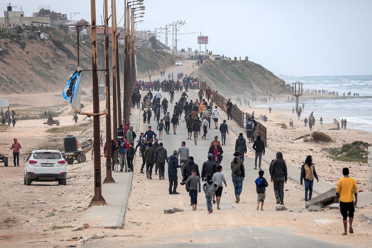Displaced Palestinians fleeing from the area in the vicinity of Gaza City's al-Shifa hospital walk along the coastal highway as they arrive at the Nuseirat refugee camp in the central Gaza Strip on March 18, 2024 amid the ongoing battles between Israel and the militant group Hamas. (Photo by AFP)