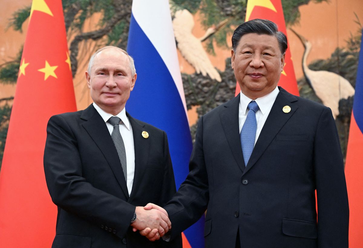 This pool photograph distributed by Russian state owned agency Sputnik shows Russia's President Vladimir Putin and Chinese President Xi Jinping shaking hands during a meeting in Beijing on October 18, 2023. (Photo by Sergei GUNEYEV / POOL / AFP) putyin, hszi