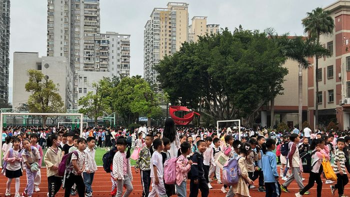 Diákok menekülnek a kelet-kínai Fujian tartománybeli Hsziamen egyik iskolájának játszóterére