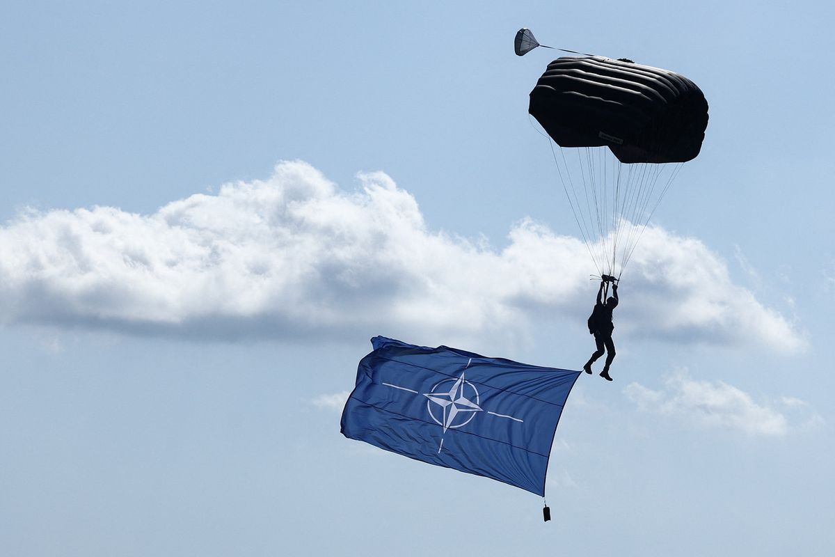 RADOM, POLAND - AUGUST 26: A paratrooper with NATO flag performs during the Air Show in Radom, Poland on August 26, 2023. The biggest air show in Poland remains two days and are held for the first time after a five-year break. Jakub Porzycki / Anadolu Agency (Photo by Jakub Porzycki / ANADOLU AGENCY / Anadolu via AFP)
NATO
