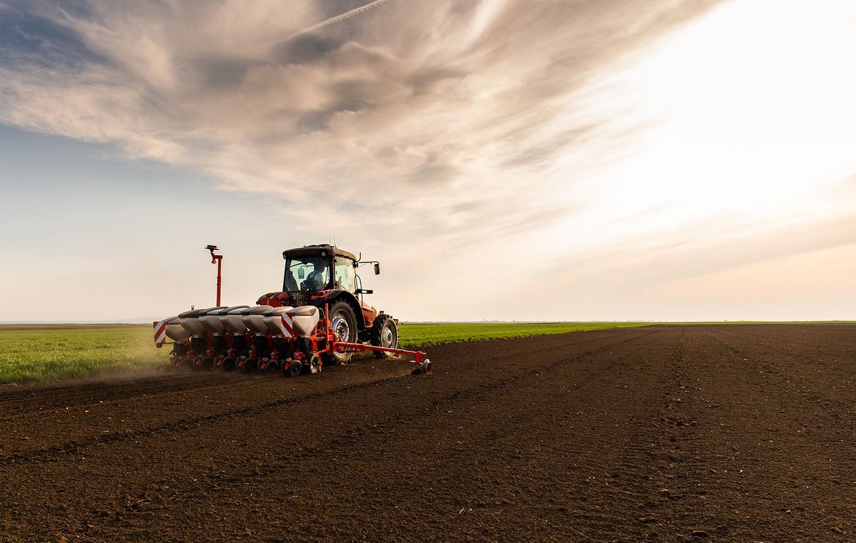 Farmer,With,Tractor,Seeding,-,Sowing,Crops,At,Agricultural,Fields