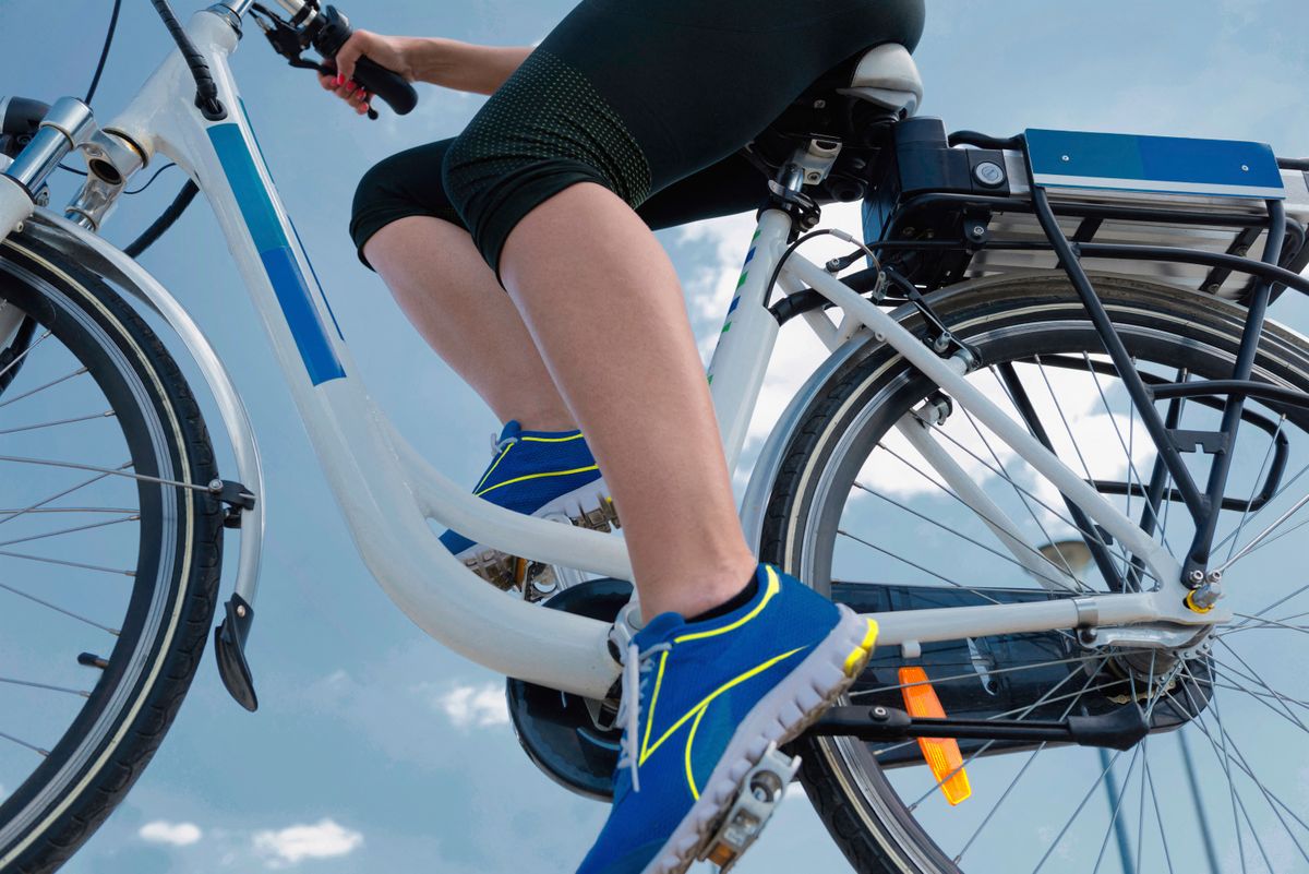 Young woman riding electric bicycle